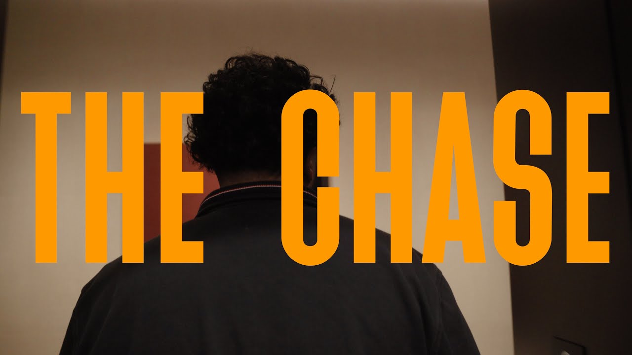 The Chase short film title over a character seen from behind.